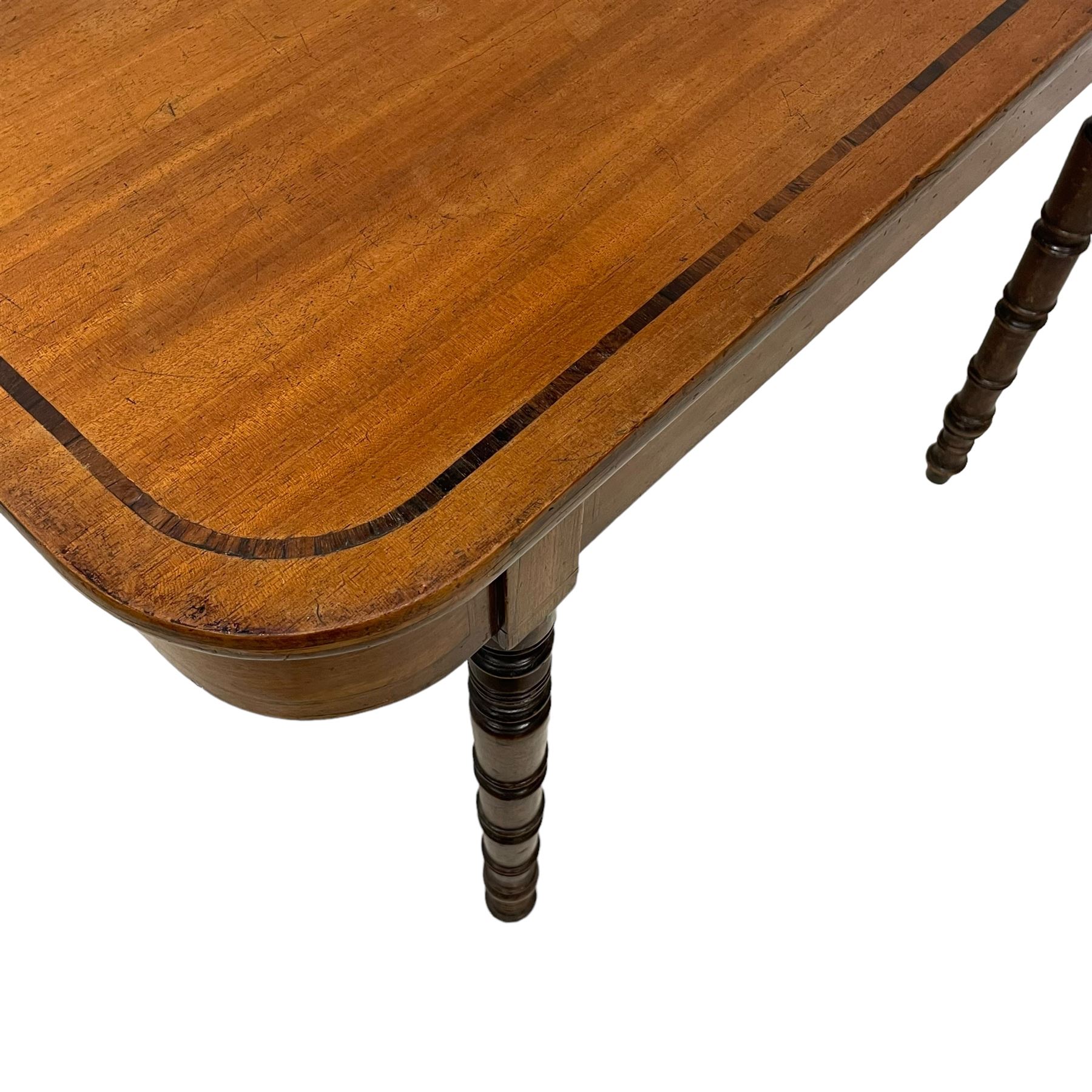 Early 19th century mahogany tea table, rectangular fold-over top with rounded corners, inlaid with mahogany banding, the plain frieze with mahogany stringing, raised on gate-leg action ring turned supports