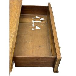 Late Victorian oak twin pedestal desk, chamfered rectangular top over three convex front edge drawers and two panelled cupboards, flanked by carved supports with roundels and diamond motif, on bracketed plinth base