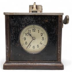 Early 20th century- Pidgeon clock, cast steel case with a silver finished lid and cast brass fittings, glazed circular dial with Arabic numerals, minute track and steel spade hands, spring driven balance escapement. No Keys.