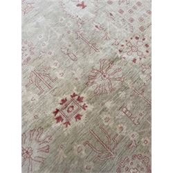 Persian design pale ivory ground carpet, decorated with stylised plant and leaf motifs in pale red