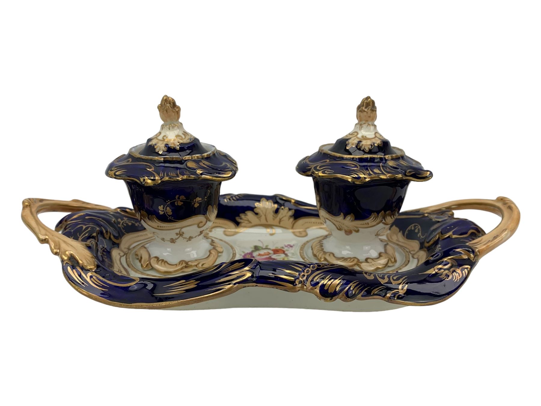 19th century porcelain inkstand, the oblong twin handled base centrally painted with a floral bouquet, flanked by two footed inkwells and covers, with rococo-inspired acanthus moulded borders and handles, pattern no. 2/3339, L26.5cm 