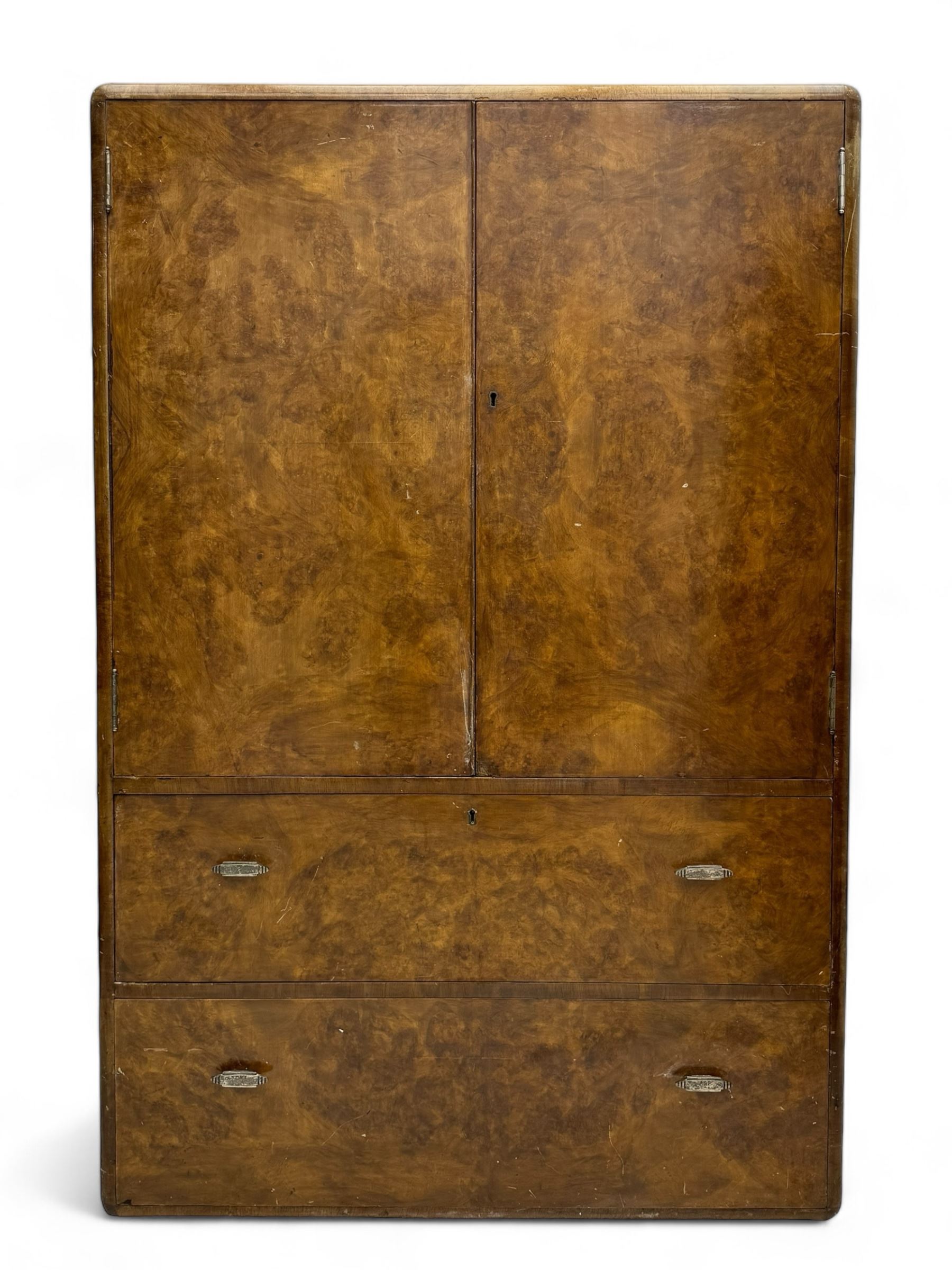 Early 20th century burr walnut cabinet, rectangular top with raised back, over double-door cupboard enclosing camphor interior with single shelf, lower section fitted with two drawers