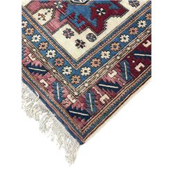 Turkish camel ground rug, three medallions surrounded by geometric motifs, the border decorated with stylised leaf motifs