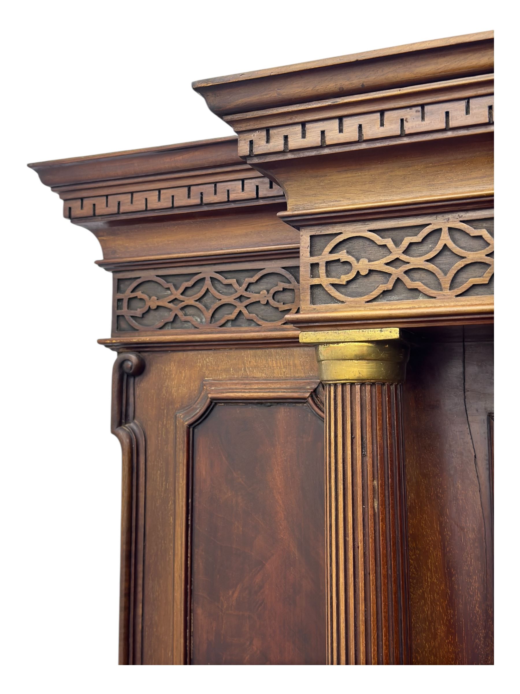 19th century mahogany sideboard, raised mirror back with carved fretwork and two fluted columns, above two cupboards and two drawers with lion mask handles