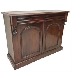 Victorian mahogany chiffonier, raised shaped back with foliage scroll carved mounts, on fretwork and carved bracket supports, moulded rectangular top over two frieze drawers and double panelled cupboard, on moulded plinth base