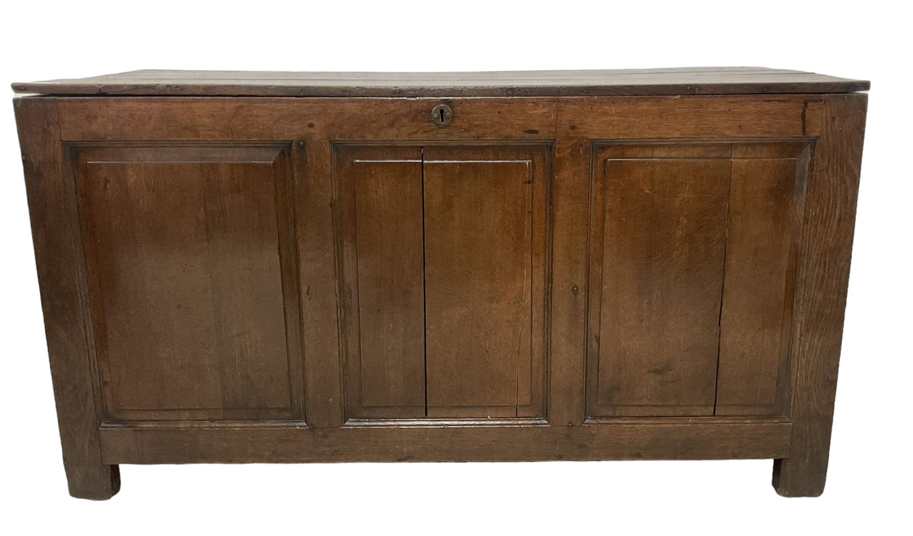 Large 18th century oak coffer or blanket box, hinged lid over triple panelled front, panelled back and sides, on stile supports 