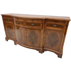 Wade - Georgian design yew wood bow-fronted sideboard, projecting moulded top over four cockbeaded frieze drawers, the central two with pull-out slides, four cupboards below with figured veneers, raised on bracket feet