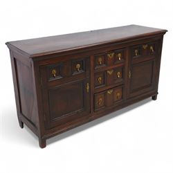 George III elm dresser base, the rectangular top with moulded edge, fitted with three cent...