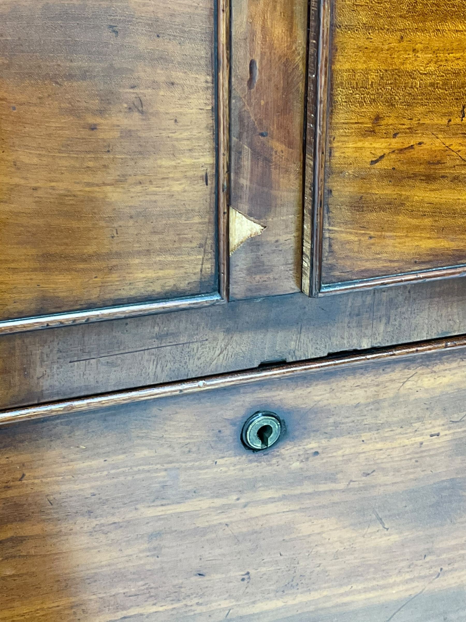 Victorian figured mahogany linen-press, projecting moulded cornice over two arch panelled doors, fitted with two short and two long cock-beaded drawers, on turned feet