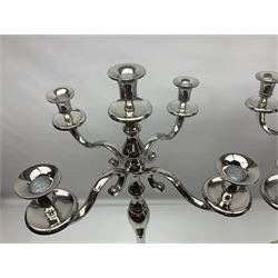 Pair of four branch candelabras, urn-shaped nozzles raised upon scroll branches supported from tapering central stem, with circular base, H70cm