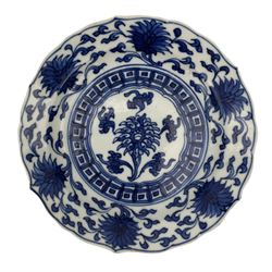 19th century Chinese blue and white saucer dish decorated in the Long Eliza pattern, four character mark within double circle beneath, D13.5cm, and a Chinese shaped dish painted with lotus flowers, provincial shop mark within square border beneath (2)