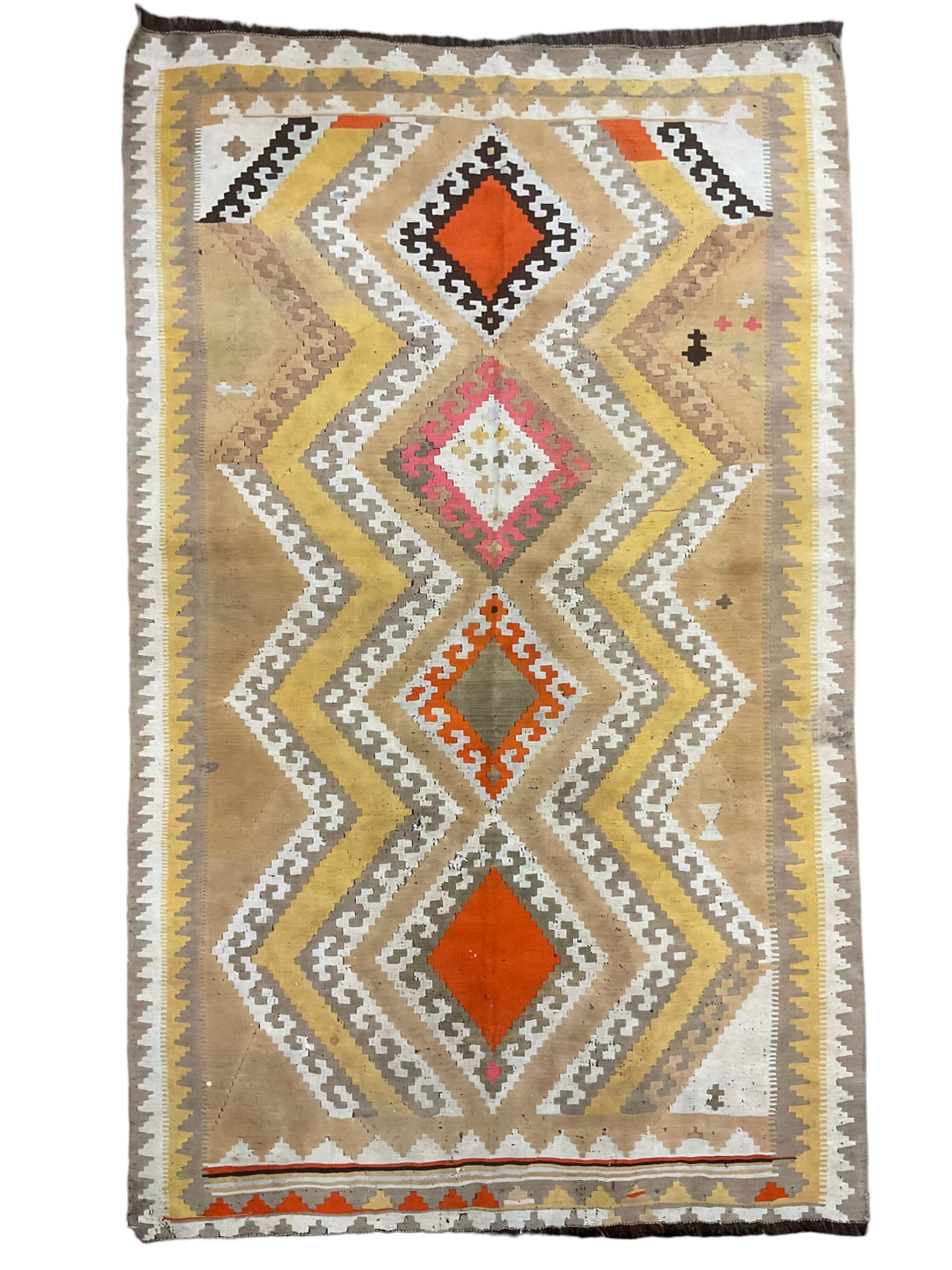 South West Persian Qashgai Kilim, mustard ground and decorated with geometric lozenges and borders 