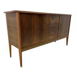 Mid 20th century teak sideboard, rectangular top with rounded corners over three central drawers, flanked by two cupboard doors enclosing shelves, raised on tapered supports