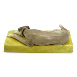 Late 19th century Sampson Hancock Derby porcelain model of a recumbent greyhound wearing a black collar, on a rectangular green painted base, initialled H.W with iron red marks beneath, L13.5cm x H4.5cm