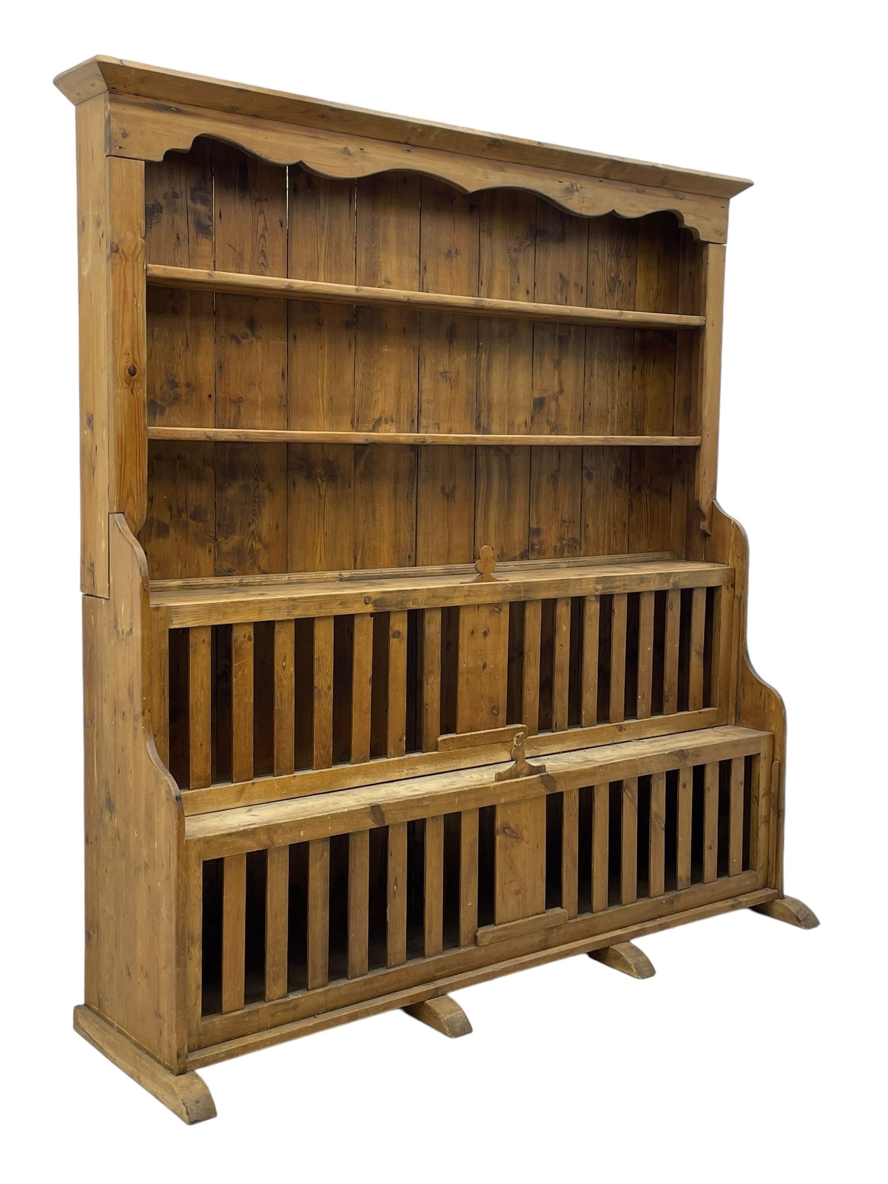 Waxed pine 'chicken coop' or 'hutch' dresser, projecting cornice over shaped frieze and three tier plate rack, the stepped waterfall lower section fitted with two slatted chicken coops, on sledge feet 