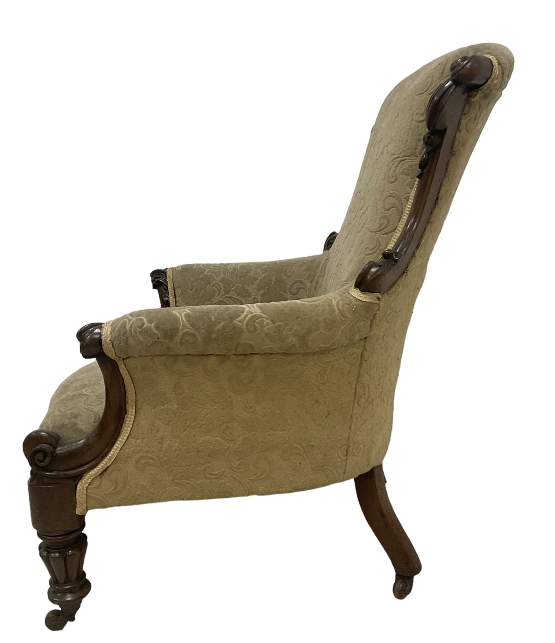 William IV mahogany framed armchair, rolled back with scroll carved uprights, acanthus carved arm terminals over serpentine fronted seat, raised on turned and lobe carved supports with castors