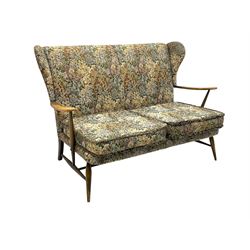 Lucian Ercolani for Ercol - mid-20th century beech and elm 'Windsor 203' two-seat sofa, wingback design upholstered in floral pattern over sprung seat and backrest, open curved arms, on splayed supports with stretchers (W133cm, D87cm, H90cm); matching easy chair (W70cm, D97cm, H82cm)