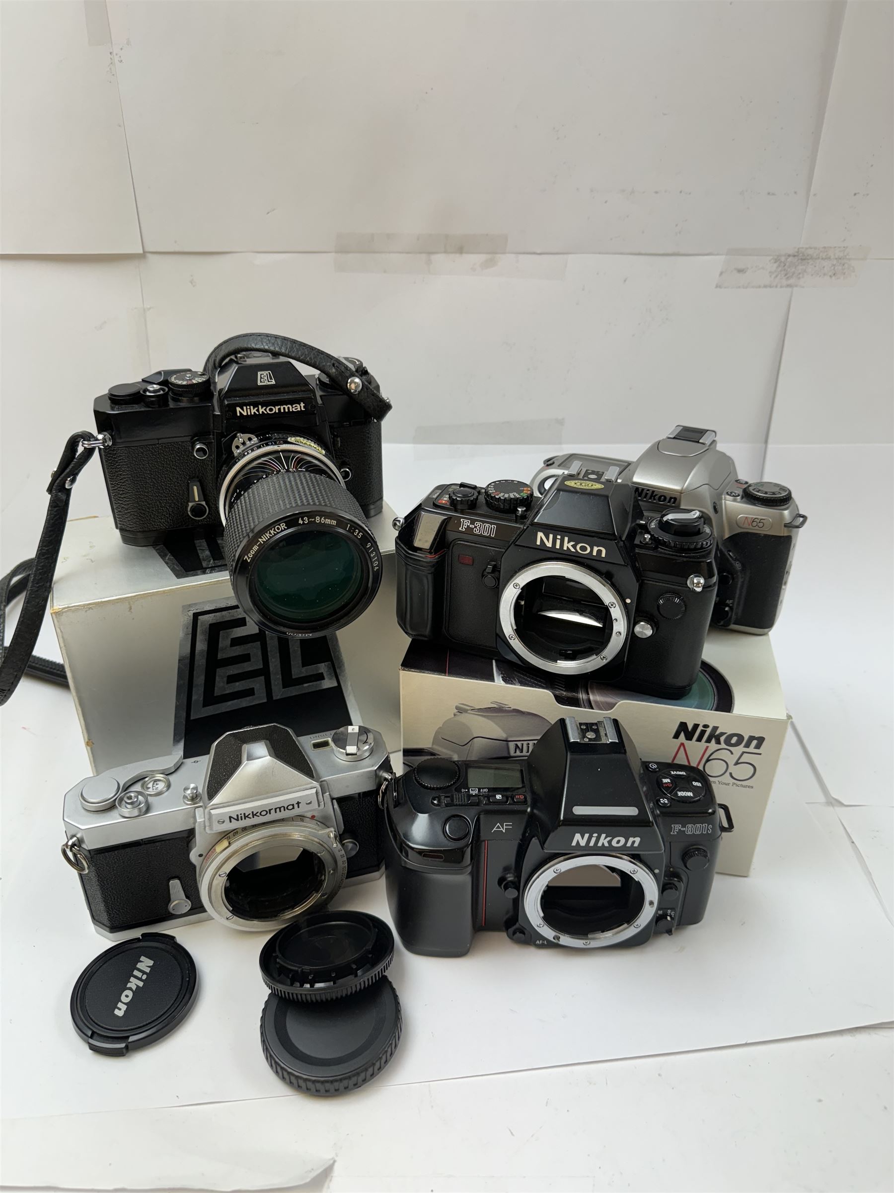 Collection of Nikon cameras, to include N65 serial no. 3103095, boxed, AF F-601 serial no. 2049522, boxed, F-801s serial no. 3330641, F-301 serial no. 3349050 and two Nikkormat cameras, to inlcude an EL example serial no. 5236494, with a nikkor Zoom 43-86mm 1:35 lens serial no. 913104, boxed and one other