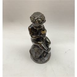 Bronzed metal model of a putti seated upon a barrel with goblet in hands, and fruiting vines adorning their head, H17.5cm