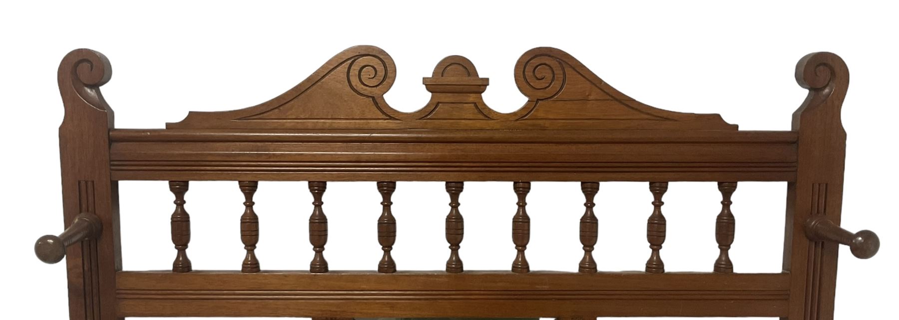 Late Victorian hallstand, raised pediment over balustrade frieze, bevelled mirror back with coat hooks over glove drawer, fitted with two drip-trays to base