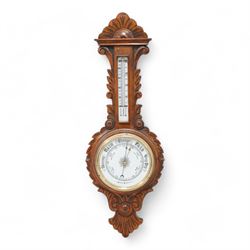 Edwardian-aneroid barometer in a carved oak case with an 8” porcelain register, steel indi...