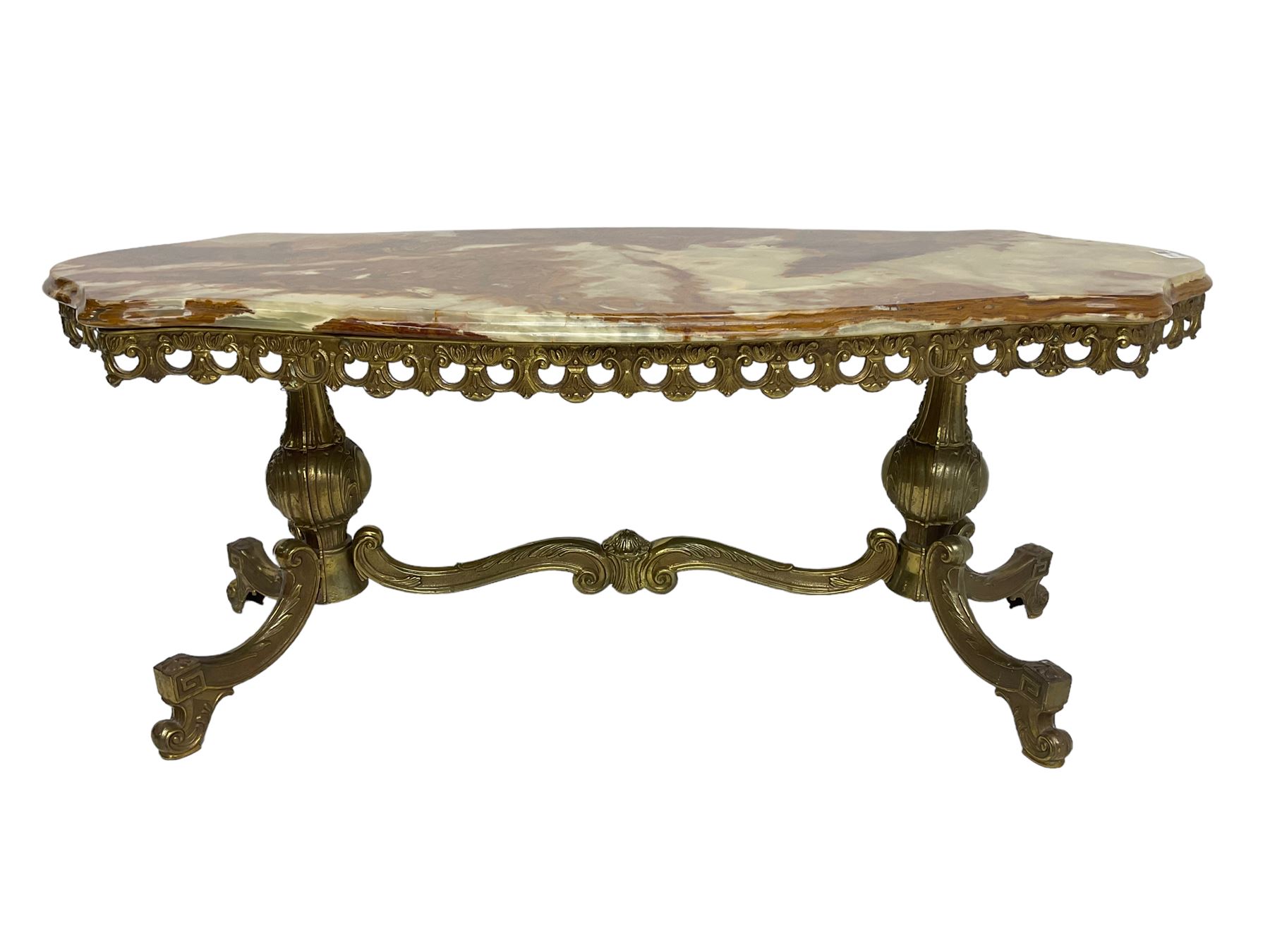 Mid-20th century Italian design Onyx and gilt serpentine coffee table, pierced gilt metal frieze with scrolling decoration, raised on twin end supports with globular turning and foliate decoration united by shaped scroll stretcher