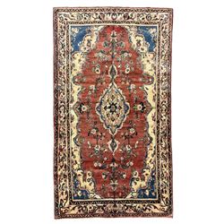 Persian Mahal red ground rug, central floral design pole medallion on a field decorated with flowerheads and foliage, the border decorated with trailing leafy branch and flowerheads 