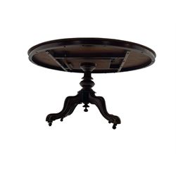 Victorian mahogany loo or dining table, oval moulded tilt-top on turned pedestal, four out splayed supports with scrolled carved terminals (137cm x 101cm, H75cm); together with set of four Victorian dining chairs upholstered in pale buttoned fabric, on turned front supports with brass and ceramic castors  