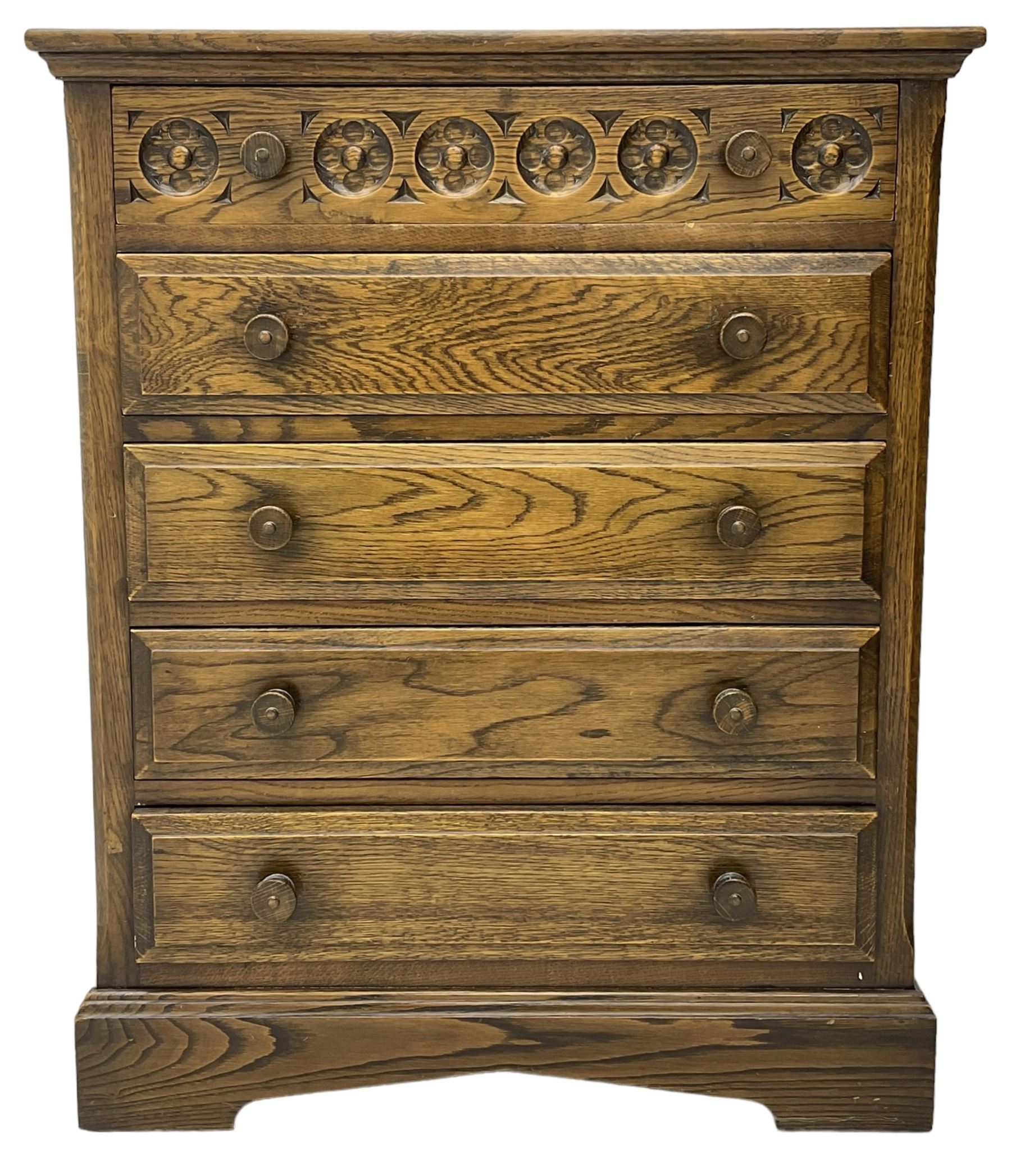 Mid-20th century oak chest, fitted with five drawers, the top drawer carved with flower head roundels, on bracketed plinth base 