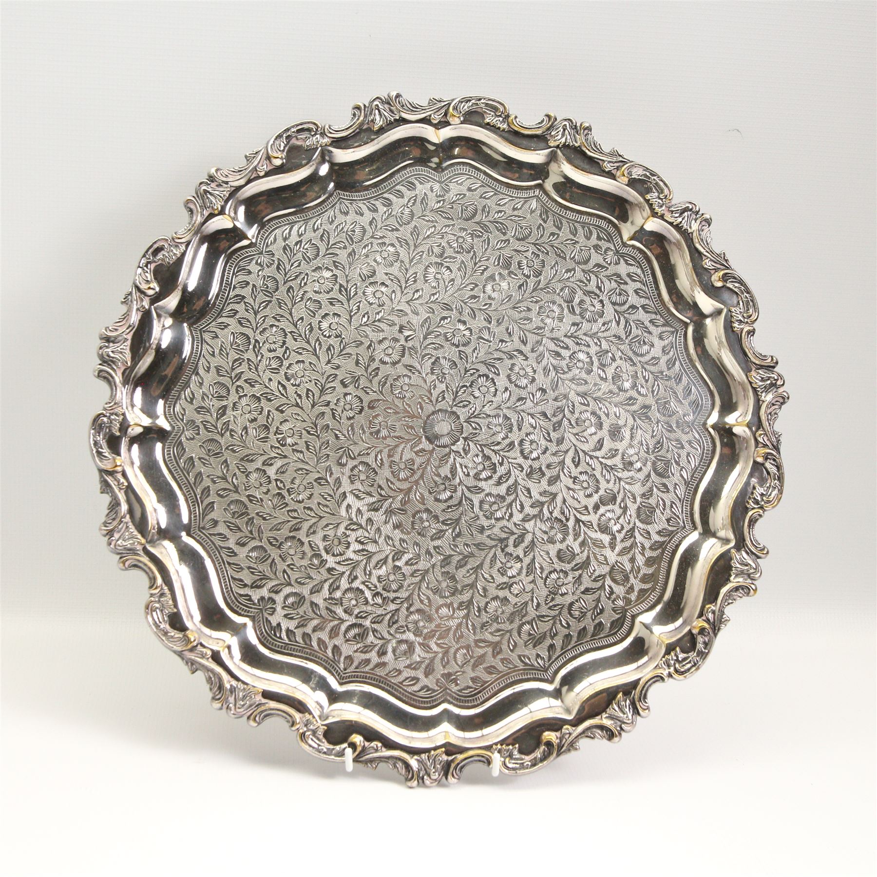 Continental silver-plated part dinner service comprising two graduated entree dishes & oval platters and salver, all having scroll cast borders and foliate engraved design, oval tray max L65cm 