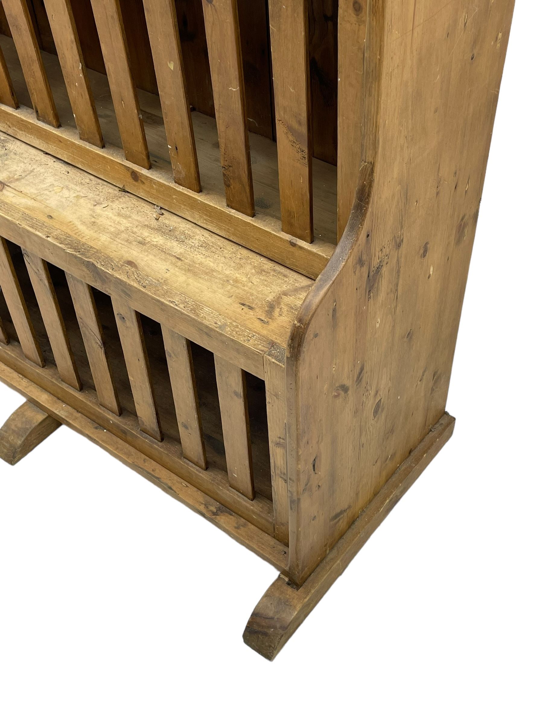 Waxed pine 'chicken coop' or 'hutch' dresser, projecting cornice over shaped frieze and three tier plate rack, the stepped waterfall lower section fitted with two slatted chicken coops, on sledge feet 