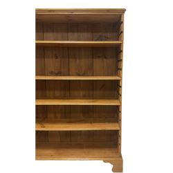 Georgian and later pine open bookcase, fitted with three adjustable shelves, on bracket feet