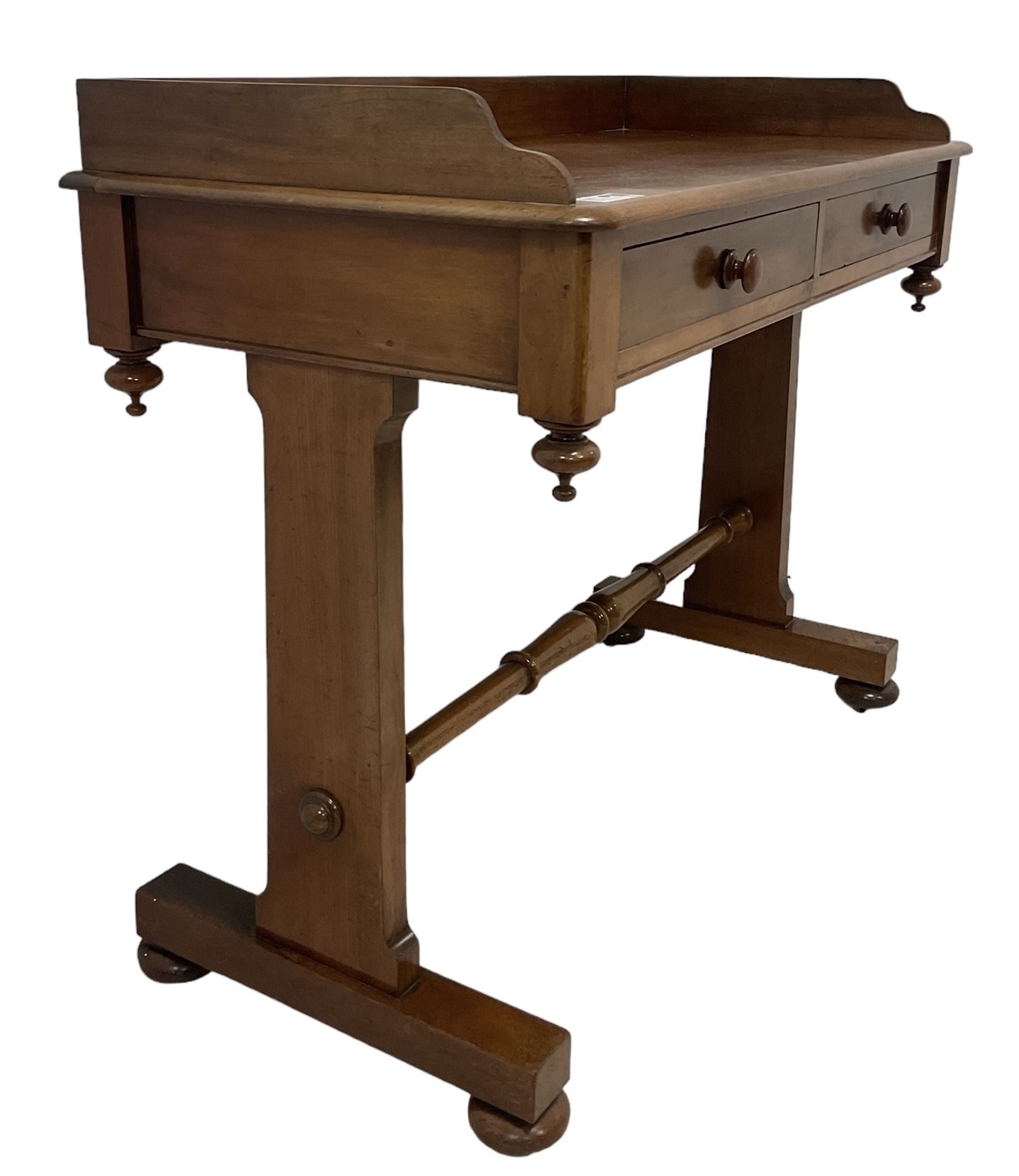 Victorian mahogany washstand, three-quarter raised gallery back, rectangular top with over two drawers, on shaped end supports united by ring-turned stretcher