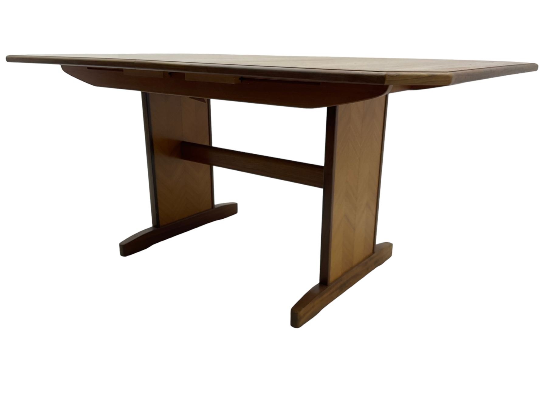 G-Plan -  1970s teak extending dining table, pull-out extending action with fold-out leaf, rectangular end supports on sledge feet united by stretcher (100cm x 160cm - 205cm, H73cm); set of six dining chairs, chevron-patterned backrests upholstered with floral patterned fabric, on tapered legs, H89cm