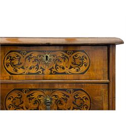 18th century inlaid walnut chest on stand, ovolo-moulded rectangular top inlaid with ebony panels each decorated with scrolling foliage, flower heads and birds, fitted with two short over three long drawers, the drawer fronts decorated with ebony panels enclosing curled leaf inlays, the base fitted with single drawer on turned supports united by waved stretchers, on turned bun feet 