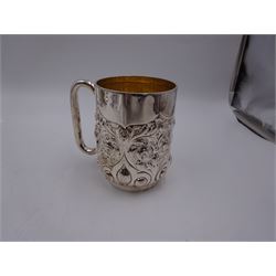 Late Victorian silver christening mug, with C handle and gilt interior, the body profusely embossed with floral and foliate decoration, hallmarked Atkin Brothers, Sheffield 1897, H10cm