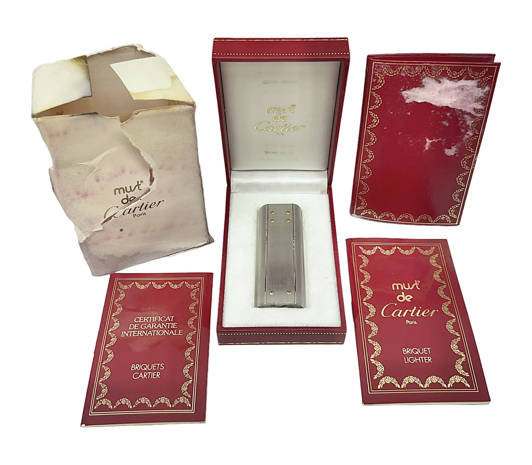 Must de Cartier stainless steel lighter, with gold plated accents, stamped Cartier to base, boxed with guarantee