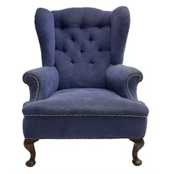 Early 20th century wingback armchair, upholstered in buttoned blue fabric, rolled and scrolled arms, on cabriole feet