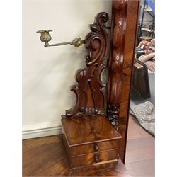 Tall Victorian figured mahogany twin pedestal dressing table, the tall mirror with flower head and scrolled leaf carved pediment, flanked by two turned and carved finials over faceted lancet arched lantern tops, plane mirror plate enclosed by shaped frame, pierced and undulating moulded uprights, on C-scroll and curled leaf carved supports fitted with cast brass hinged candle sconces, each pedestal fitted with two small trinket drawers over larger drawer and panelled cupboard, canted corners with matched upright mounts, the cupboard doors enclosing slides, on scroll carved feet 