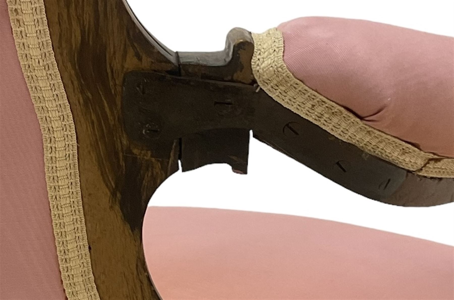 Victorian mahogany framed open armchair, spoon-back and sprung seat upholstered in pink fabric, scrolled arm terminals over serpentine fronted seat decorated with moulded carved floral motifs, cabriole supports with ceramic castors