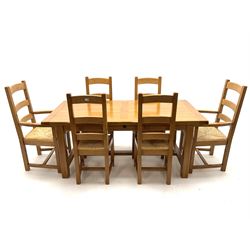 Light oak rectangular dining table with two leaves, square supports joined by floor stretcher (W280cm, H77cm, D90cm) and set six (4+2) ladder back chairs, rush seat (W60cm)