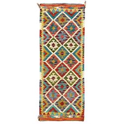 Chobi Kilim ground runner, the field decorated with a geometric pattern of coloured diamonds and triangles, each containing stylised motifs, the shorter ends enclosed by a plain border, and the longer sides with a multicoloured border

