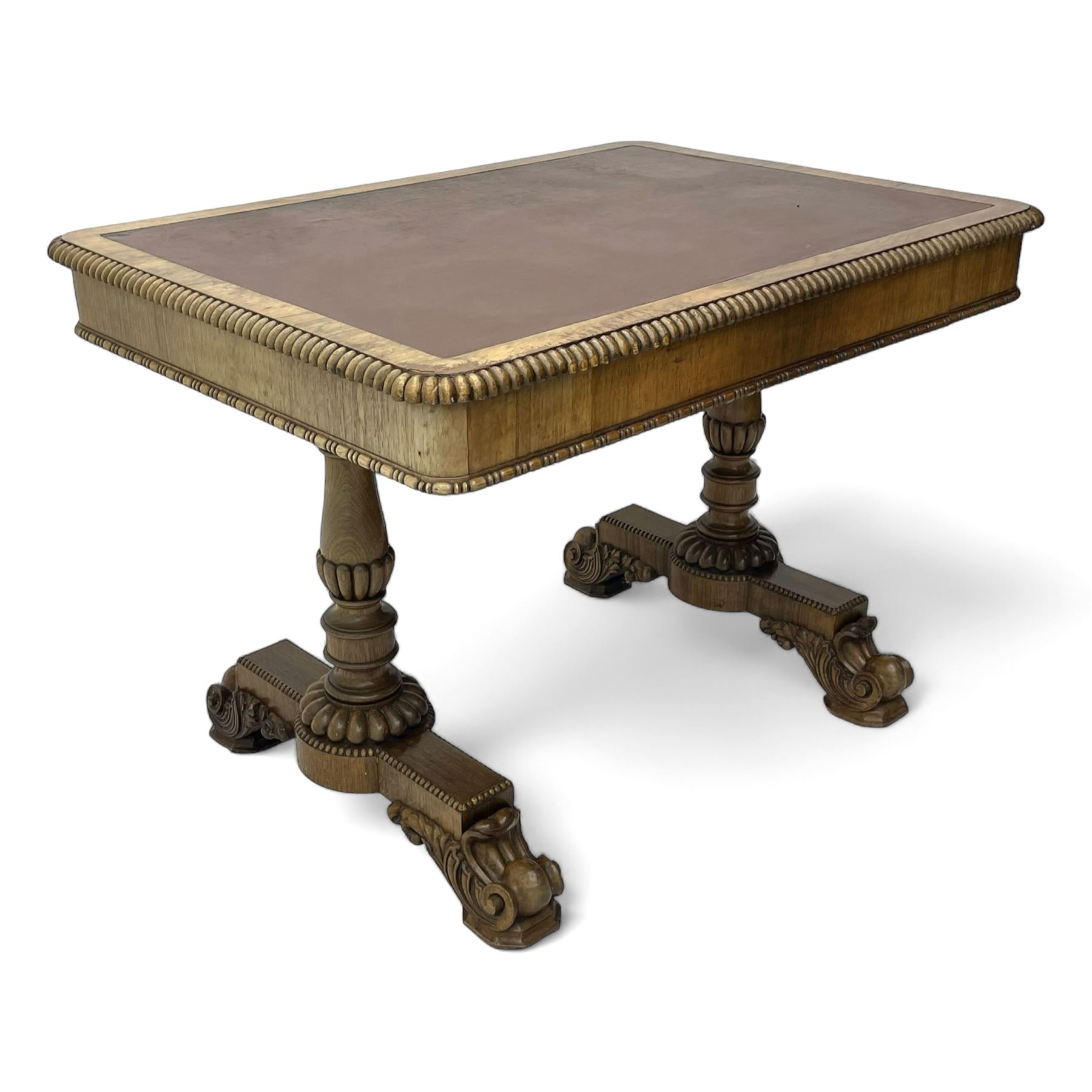 Early 19th century Regency rosewood writing table, rectangular top with inset leather writing surface and gadroon moulded edge, fitted with single frieze drawer, on twin turned pillar supports with lobe carved balusters, on platforms with beaded edge, acanthus scroll carved feet