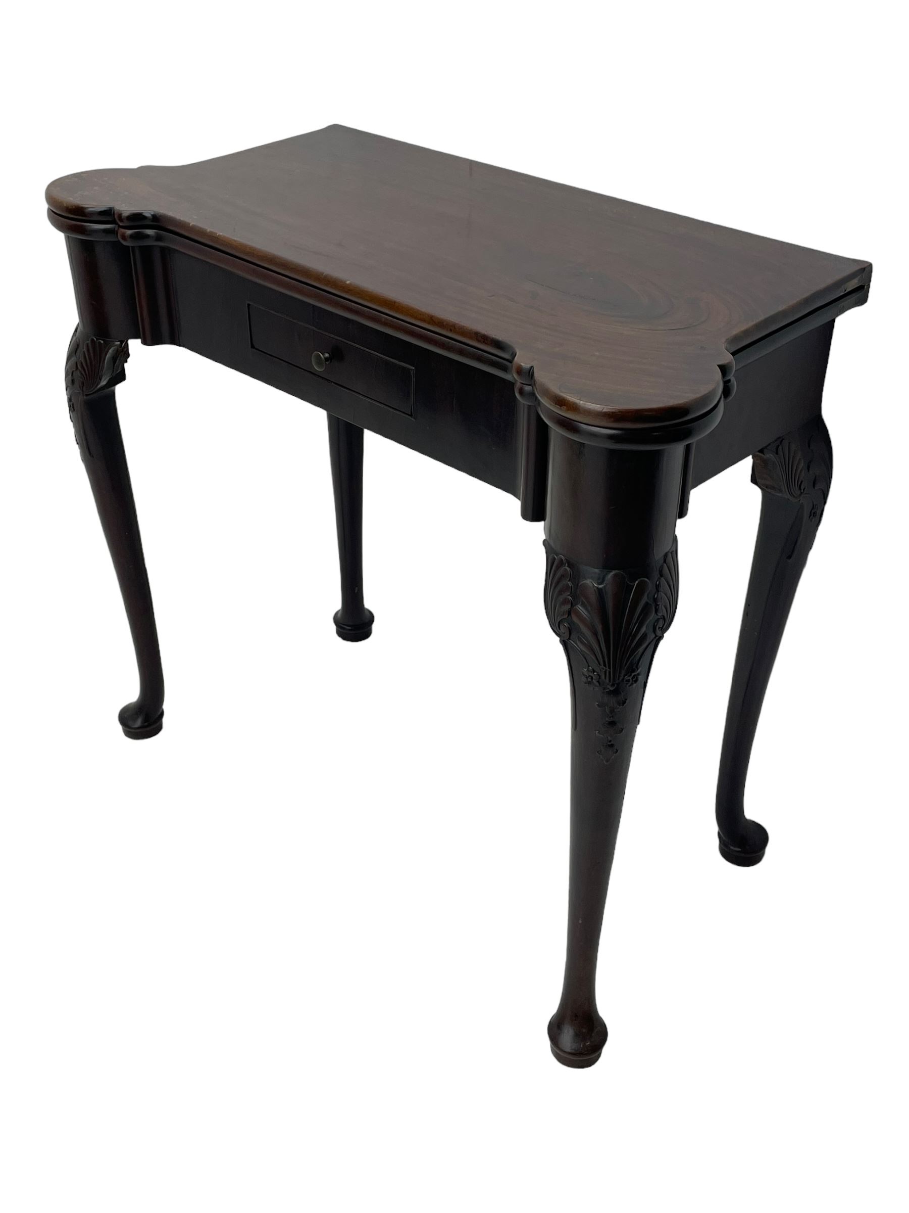 Late 18th century Irish mahogany tea table, rectangular form with projecting stepped rounded corners, fold-over action top over single frieze drawer within cock-beaded surround, on shell and bellflower carved cabriole supports, single gate-leg action base 