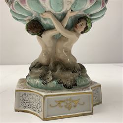 Early 20th century continental pedestal jar with cover, the bowl held aloft by four mermaids and decorated with putti playing instruments in a lake, the fluted domed cover topped with cherub playing a horn, H38cm