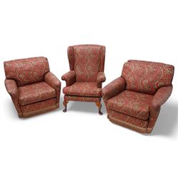 Three-piece lounge suite - pair of armchairs with rolled arms (W85cm, H74cm, D95cm); wingback armchair on cabriole feet (W74cm, H97cm, D73cm), upholstered in crimson ground floral pattern fabric 