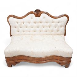 Victorian mahogany frame settee, shaped cresting rail with fan carved cresting, upholstered in buttoned cream fabric with repeating floral pattern, low serpentine seat, shaped and pierced bracket feet, on brass castors 