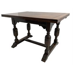 Mid-20th century medium oak dining table, rectangular draw-leaf extending top, quadruple turned pillar supports on sledge feet joined by stretcher