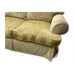 Contemporary two-seat sofa, upholstered in damask fabric with a pale gold floral pattern, rolled arms, loose back and seat cushions, on matching skirted base with concealed castors