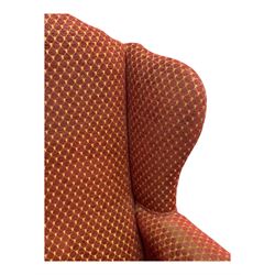 Early 20th century hardwood-framed wingback armchair, upholstered in red dotted fabric, on cabriole feet